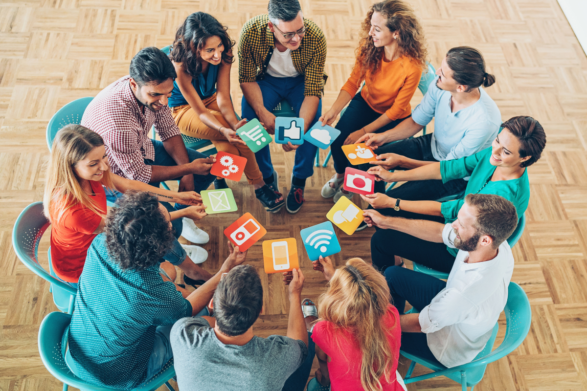 overhead of group of people holding social media icons