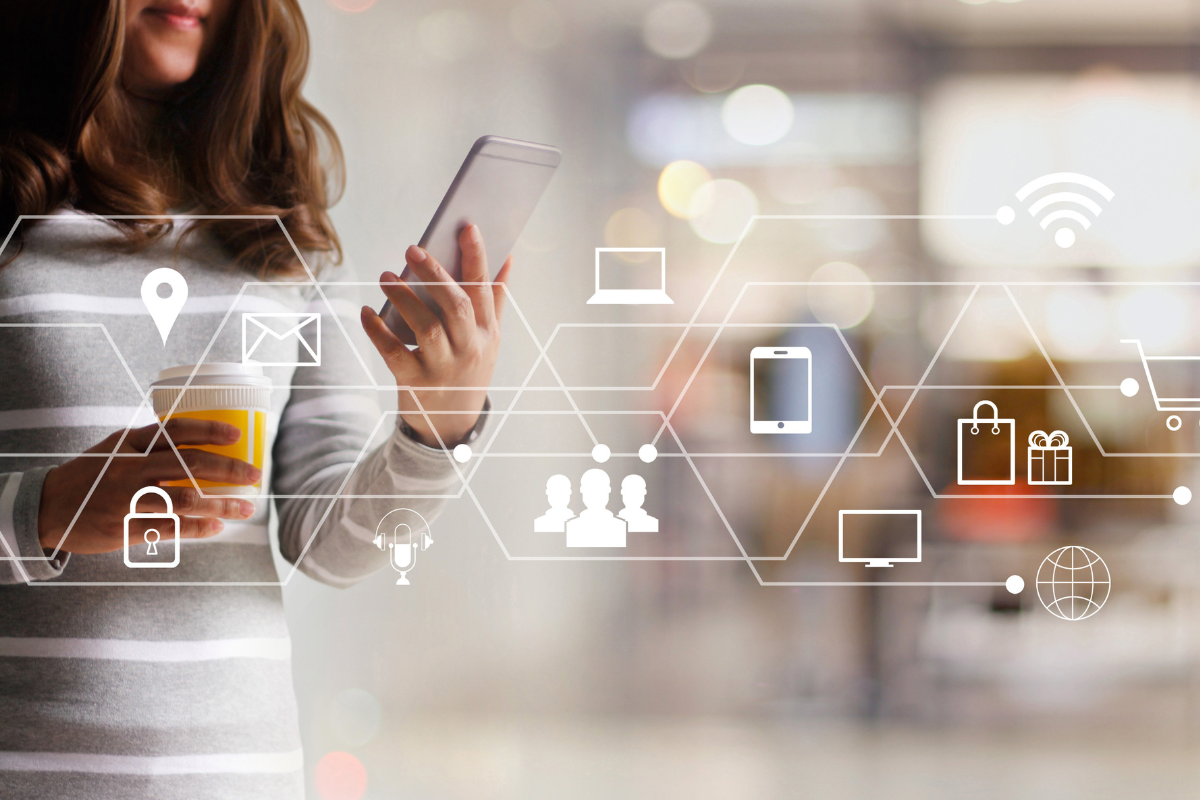 woman holding phone with brand design graphics